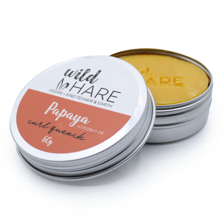 rund metal dåse i grå, åben med visuel gul shampoo bar